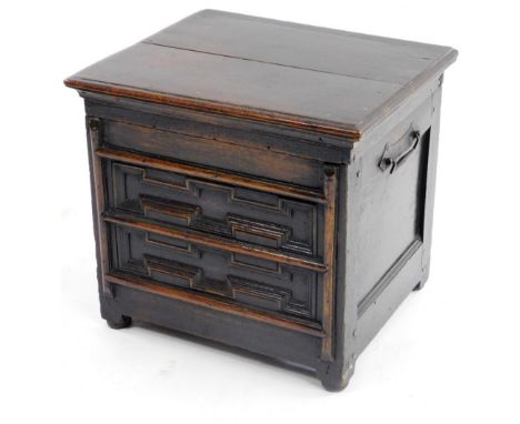 A late 17thC/early 18thC oak box commode, the hinged rectangular lid with a moulded edge enclosing a vacant interior, with a 