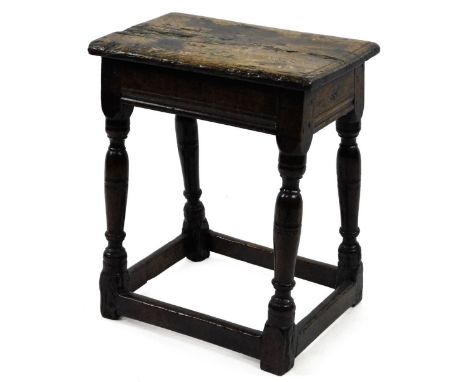A 17thC oak joint stool, the rectangular top with moulded edge on turned supports with stretchers, carved with the initials E