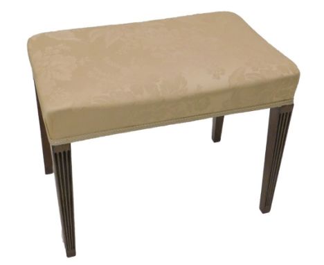 A George III mahogany stool, the rectangular padded top upholstered in beige damask type material, on square tapering reeded 