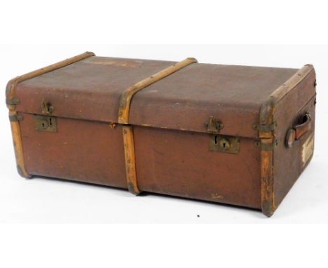 An early 20thC pressed leather steamer trunk, with part wooden banding, leather handles and fitted interior, with labels, 33c