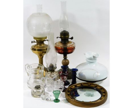 An early 20thC brass oil lamp, with frosted and clear glass shade, with a fixed reservoir, fluted stem and domed foot, 52cm H