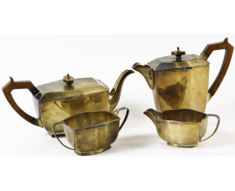 A George V silver Art Deco four piece tea service, with a diamond sun motif to the coffee pot, teapot, two handled sugar bowl