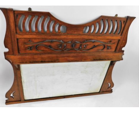 A late 19thC oak Art Nouveau over mantel mirror, the heavily carved top above a shelf and rectangular bevelled glass, flanked