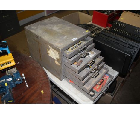 A metal slim seven drawer filing cabinet and contents of various workshop tools