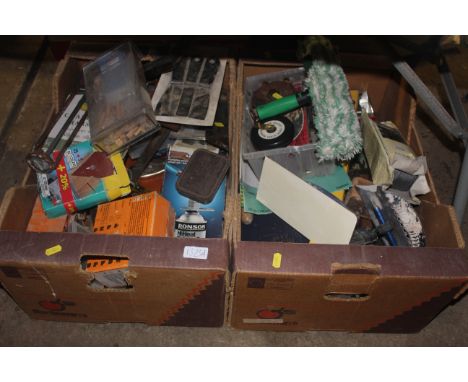 Two boxes containing various items including cork gun, various hand tools, fixings, spirit level etc