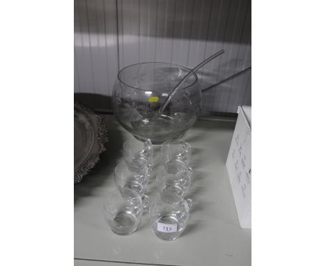 A glass punch bowl, ladle and cups