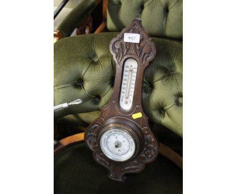 A carved oak cased aneroid barometer and thermometer