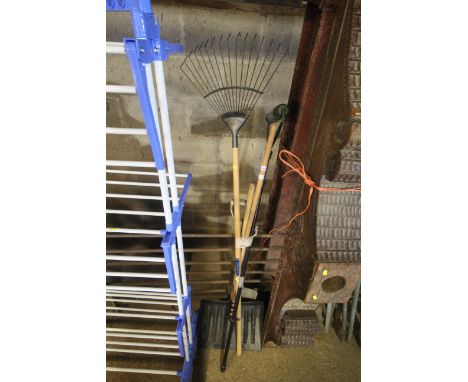 A quantity of long handled tools to include rake, snow shovel, paint roller etc.