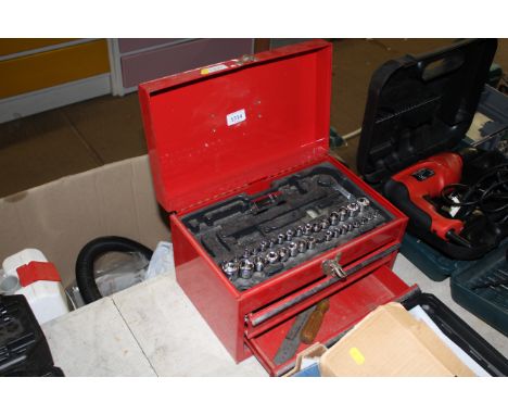 A small red metal tool chest and contents of part socket set