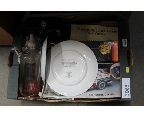 A box containing Copeland Spode plate depicting the Philadelphia Orchestra, a soda syphon, remote control patrol car etc. 