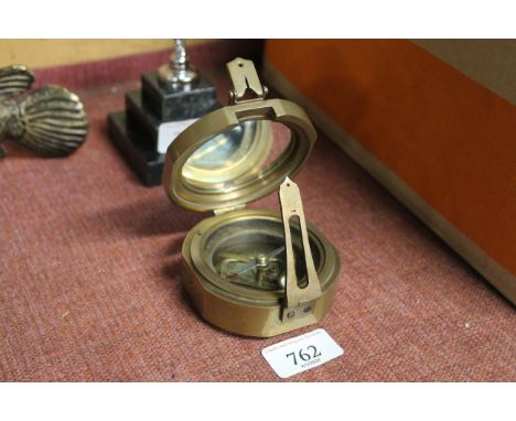 A reproduction brass compass (78)