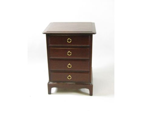 A Stag mahogany bedside chest, of four drawers, raised on bracket feet, 53cm high, 46cm wide, 71cm long, together with a maho