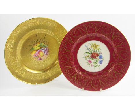 A Royal Worcester porcelain plate painted with fruit by H Henry, against a gilt tooled ground, 27.5cm diameter, and a further