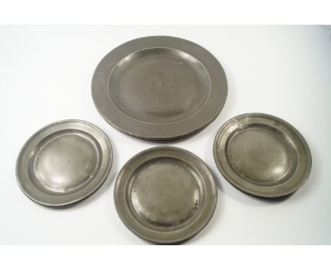 Three 19thC pewter chargers, two bearing evidence of touch marks, 35cm diameter, together with eight plates, 21cm diameter, (