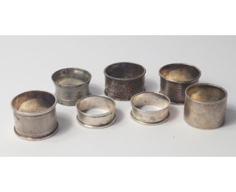 Six Victorian and later silver napkin rings, one with engraved foliate decoration, two with engine turned decoration and thre