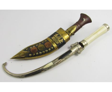 A Nepalese Kukri with wooden handle and leather sheath, overlaid with brass and coins, 30cm long, and a bone handled knife wi