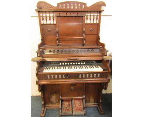 A late 19thC American mahogany cased organ by Cornish and Co Washington, N.J., with carved pediment, back with bobbin turning