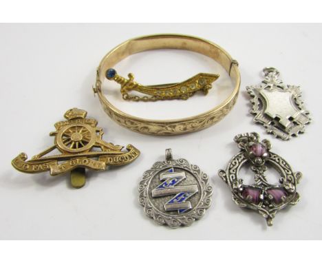 A lady's 9ct gold plated bangle, foliate engraved, on a snap clasp, two silver medallions, Royal Engineers cap badge and two 