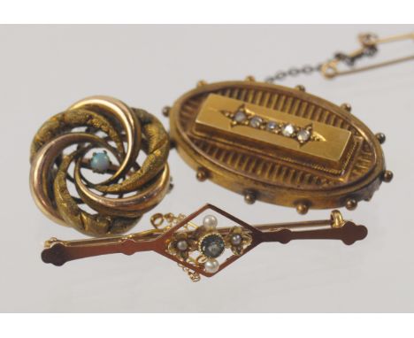 A 15ct gold bar brooch, an oval brooch with memorial locket and a costume brooch set with an opal, (3).