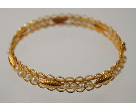 A yellow metal and seed pearl set bracelet with a pin link clasp, marked 22ct, 14.9g.