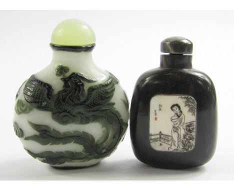 A Peking glass overlaid snuff bottle, decorated with a phoenix and dragon chasing a flaming pearl, 6.5cm high, and a horn snu