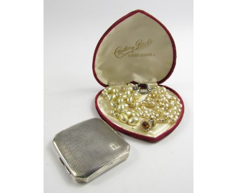 A George V silver curvilinear cigarette case, with engine turned decoration, reserve monogram, internal presentation engravin