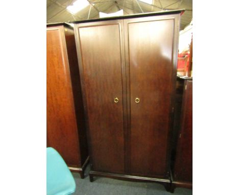 A Stag mahogany two door wardrobe, raised on bracket feet, 96cm high, 59cm wide, 178cm long.