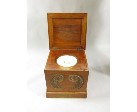 A Victorian mahogany commode with a leaf carved front, inset ceramic bucket, raised on a plinth base, 46cm x 44cm x 43cm.