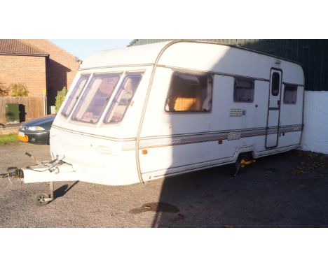 A Swift Challenger 1991/92 490/5L Caravan, 5 berth, with light oak interior, floral upholstery and ginger coloured carpet.