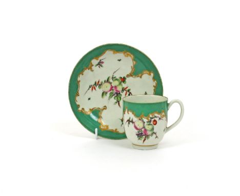 A Worcester coffee cup and saucer, c.1770, painted with arrangements of spotted fruit and single scattered sprigs within a sh