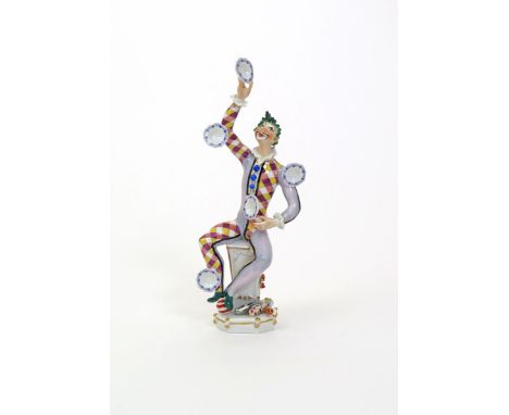 A Meissen figure of The Juggler, modern, modelled by Peter Strang, dressed in a Harlequin costume and juggling five plates be
