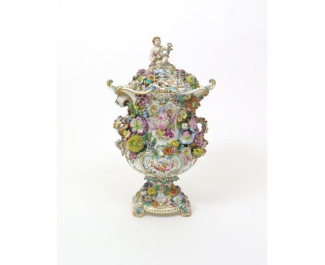 An impressive Minton porcelain vase and cover, c.1830, the urn shape richly applied with a variety of flowers, painted to one