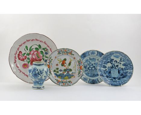 Four tin-glazed pottery plates, 18th century, including a large French faïence dish painted with flowers, a smaller North Ita