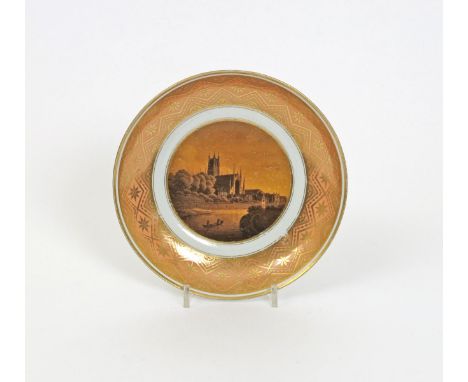 A Barr Worcester saucer dish, c.1800-5, painted in sepia with a view of Worcester Cathedral within a wide border of gilt form