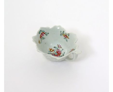A Worcester leaf-moulded butterboat, c.1755-56, formed from overlapping geranium leaves with a short stalk handle, the interi