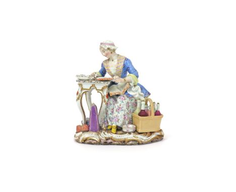 A Meissen figure of The Merchant's Wife, 19th century, after the model by J J Kändler, seated beside a small table with parce