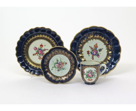 Two Worcester dessert plates, c.1780, the wells painted with star-shaped floral arrangements reserved within scrolling gilt b