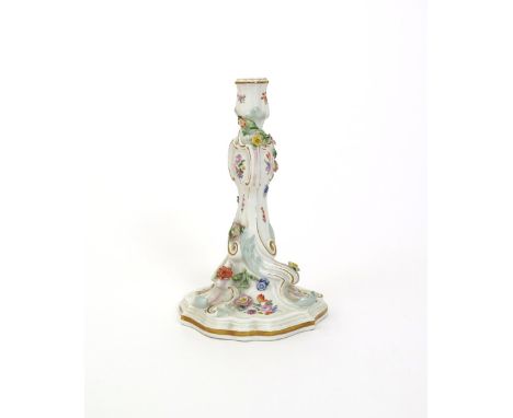 A Meissen rococo-moulded candlestick, 19th century, painted and applied with colourful flowers, moulded with scrolls highligh