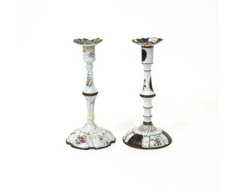 Two Bilston enamel candlesticks, c.1770, each raised on a knopped stem and set with a scalloped drip pan, painted with sprays