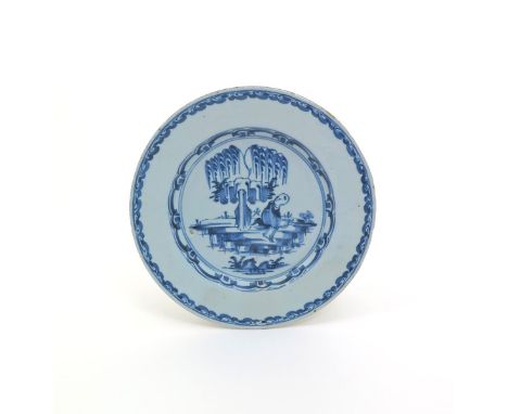 An English delftware plate, mid 18th century, painted in blue with a Chinese boy seated beneath a fringed willow tree and loo