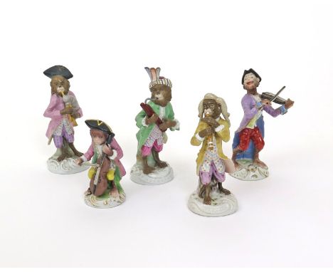 Five German porcelain monkey band figures, 19th century, after Meissen, including a bagpiper, a violinist, a cellist, a basso