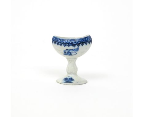 A Caughley blue and white eyebath, c.1775, printed with excerpts from the Fisherman and Cormorant pattern, raised on a moulde