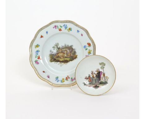 A Meissen satirical saucer, c.1765, painted with a pig wearing a bonnet and a black cape, seated at a table and admiring a bo