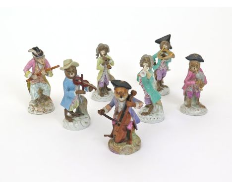 Seven Continental porcelain monkey band figures, 19th century, the hirsute musicians in 18th century dress and raised on low 