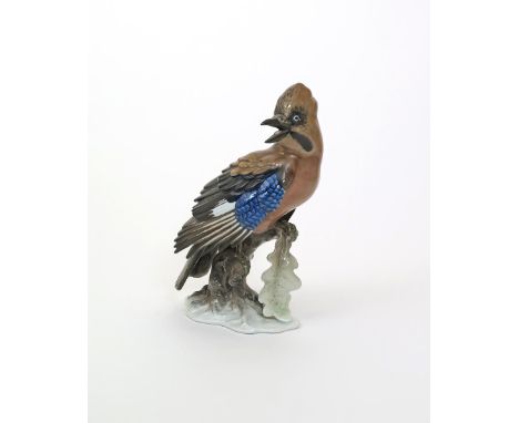 A Rosenthal model of a jay, early 20th century, modelled by F. Heidenreich, its wings partially unfurled, perched on a low br