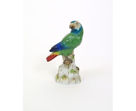 A Meissen model of a parrot, 19th century, modelled with brightly coloured plumage, his head turned over one shoulder, perche