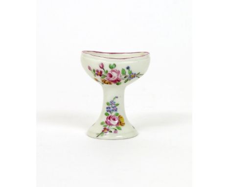 A rare Mennecy eyebath, c.1750-60, delicately painted in polychrome enamels with floral sprays to the bowl and flared stem, p