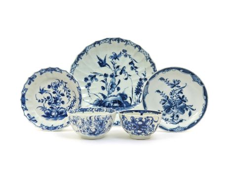 A Worcester fluted blue and white teabowl and saucer and a matching plate, c.1765, painted with the Hollow Rock Lily pattern,