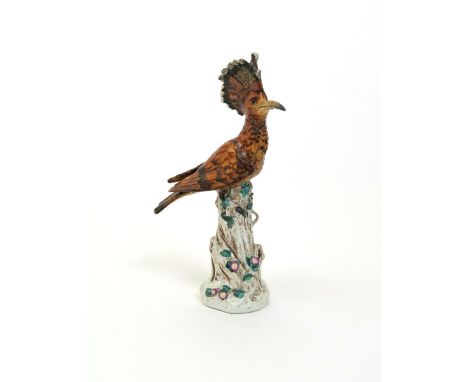 A Meissen-style model of a hoopoe, 19th century, perched atop a tall trunk with head slightly turned, enamelled in shades of 