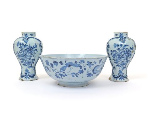 A pair of Delft vases, c.1780, moulded with scrolling cartouches and painted in blue with floral arrangements, monogram marks
